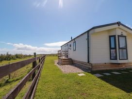 A cabin with a pathway in front at Rosefinch Cabin Staintondale near Scarborough