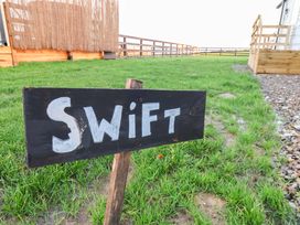A sign labeled Swift in a grassy area at Swift Cabin in Scarborough