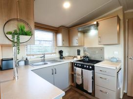 A kitchen with a sink and stove at Swift Cabin Scarborough