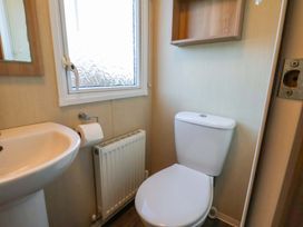 A bathroom with a sink and toilet at Swift Cabin in Scarborough
