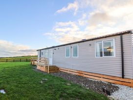 A cabin with wooden steps and windows at Swift Cabin in Scarborough