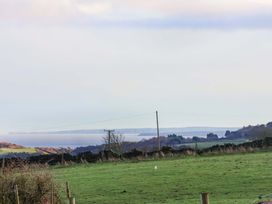 A rural landscape with water and a power line at Swift Cabin in Scarborough