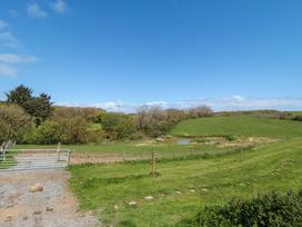A scenic outdoor view with a gate and grass at Swift Cabin in Staintondale near Scarborough