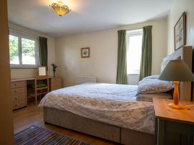 A bedroom with a bed and a desk at Oaks Lodge Cottage Ambleside