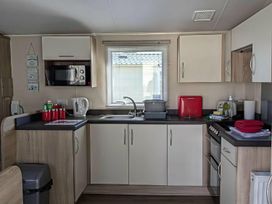 A kitchen with appliances and utensils at Coopers Beach Holiday Park - Holiday Accommodation 6404 Mersea Island