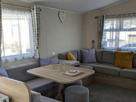 A living room with a sofa and table at Coopers Beach Holiday Park - Holiday Accommodation 6404 Mersea Island