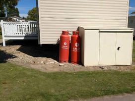 Gas cylinders and a storage unit in an outdoor area at Coopers Beach Holiday Park - Holiday Accommodation 6404 Mersea Island