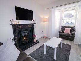 A living room with a fireplace and television at San Antonio in Dungloe, County Donegal