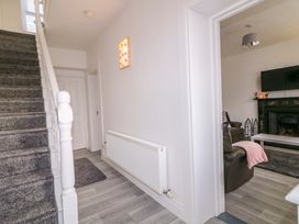 A hallway with a staircase and a view of a living room at San Antonio, Dungloe, County Donegal