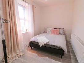 A bedroom with a bed and window at San Antonio, Dungloe, County Donegal