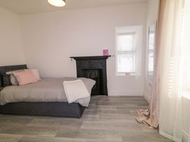 A bedroom with a bed and a fireplace at San Antonio, Dungloe, County Donegal