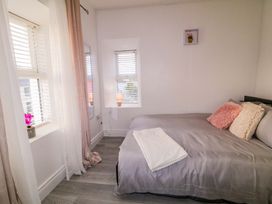 A bedroom with a bed and windows at San Antonio, Dungloe, County Donegal