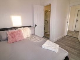 A bedroom with a bed and a shower door at San Antonio in Dungloe, County Donegal