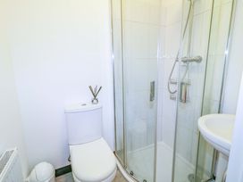 A bathroom with a shower, toilet, and basin at San Antonio, Dungloe, County Donegal