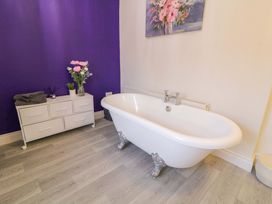 A bathroom with a bathtub and vanity at San Antonio in Dungloe, County Donegal