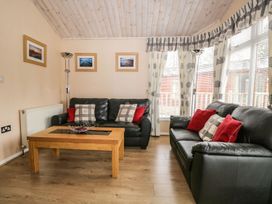 A living room with sofa and coffee table at Kingfisher Lodge in Windermere