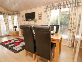 A dining area with a table and chairs at Kingfisher Lodge Windermere