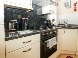 A kitchen with appliances and cabinets at Kingfisher Lodge in Windermere