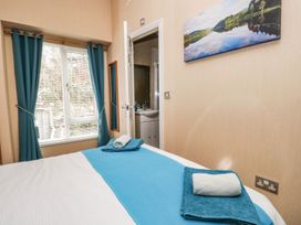 A bedroom with a bed and towels at Kingfisher Lodge in Windermere