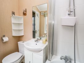 A bathroom with a sink, toilet, and shower at Kingfisher Lodge in Windermere