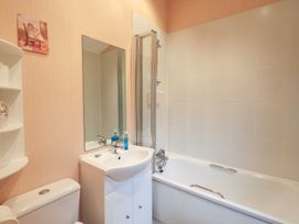 A bathroom with a bathtub and sink at Kingfisher Lodge, Grasmere 33, White Cross Bay near Windermere