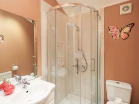 A bathroom with a shower, sink, and toilet at Kingfisher Lodge Grasmere 33, White Cross Bay near Windermere