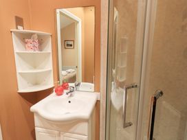 A bathroom featuring a sink and shower at Kingfisher Lodge, Grasmere 33, White Cross Bay near Windermere