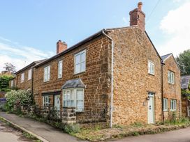 A stone house with windows and a front door at The Old Bakery in Banbury