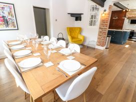 A dining room with a table set for dinner at The Old Bakery in Banbury