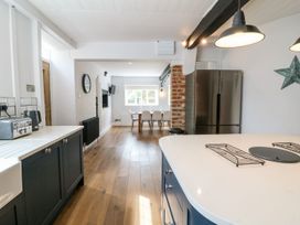 A kitchen with a table and chairs in an open space at The Old Bakery Banbury