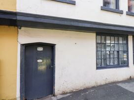 An entrance door and window on a building exterior at Stowaway Cottage in Whitby