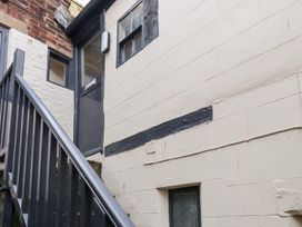 An exterior view of stairs leading to a door at Stowaway Cottage in Whitby