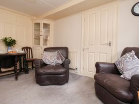A living room with chairs and a table at Stowaway Cottage in Whitby