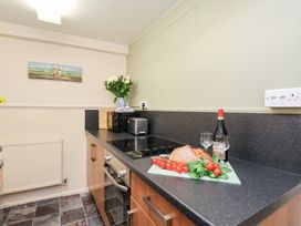 A kitchen with a countertop, stovetop, and cooking ingredients at Stowaway Cottage in Whitby