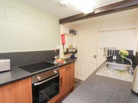A kitchen with a sink and appliances at Stowaway Cottage in Whitby