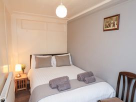 A bedroom with a bed and towels at Stowaway Cottage Whitby