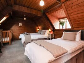 A bedroom with two beds and a crib at Stowaway Cottage in Whitby