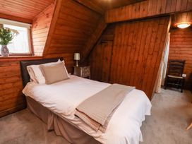 A bedroom with a bed and a window at Stowaway Cottage in Whitby