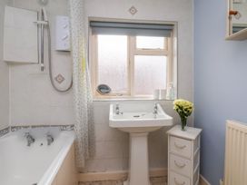 A bathroom with a bathtub and washbasin at Stowaway Cottage in Whitby