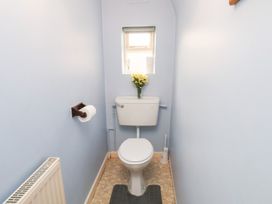 A bathroom with a toilet and sink at Stowaway Cottage in Whitby