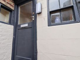 An entrance with a door and window at Stowaway Cottage in Whitby