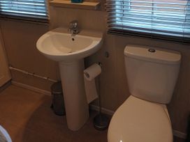 A bathroom with a sink and toilet at Fern Lodge in Stowmarket