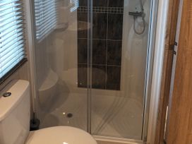 A bathroom with a toilet and shower at Fern Lodge in Stowmarket