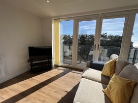 A living room with a sofa and a TV at 2A Hamilton Road Felixstowe