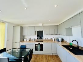 A kitchen with cabinets and appliances at 2A Hamilton Road Felixstowe