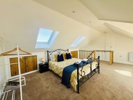 A bedroom with a bed and wardrobe at 2A Hamilton Road in Felixstowe
