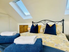 A bedroom with a bed and towels at 2A Hamilton Road Felixstowe