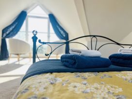 A bedroom with a bed and towels on it at 2A Hamilton Road Felixstowe