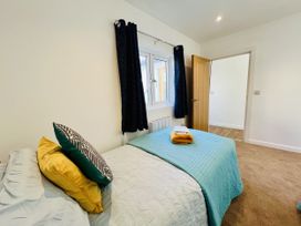 A bedroom with a bed, pillows, and a window at 2A Hamilton Road in Felixstowe
