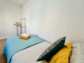 A bedroom with a bed and clothes rack at 2A Hamilton Road, Felixstowe